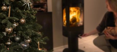 Girl firing in the wood stove at Christmas