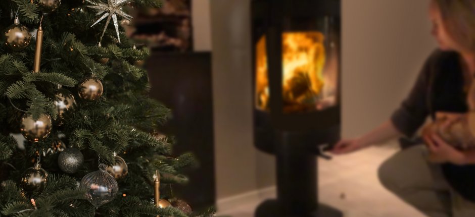 Girl firing in the wood stove at Christmas