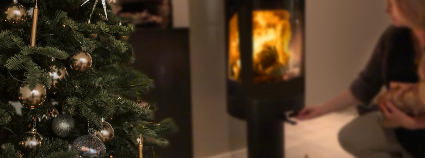 Girl firing in the wood stove at Christmas